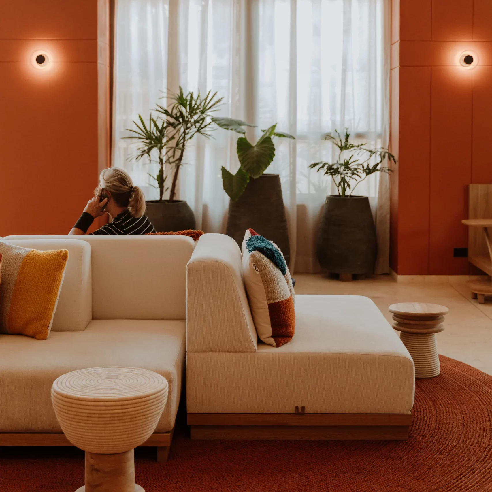Guest relaxing on sofa with colorful cushions in hotel lobby in Cartagena