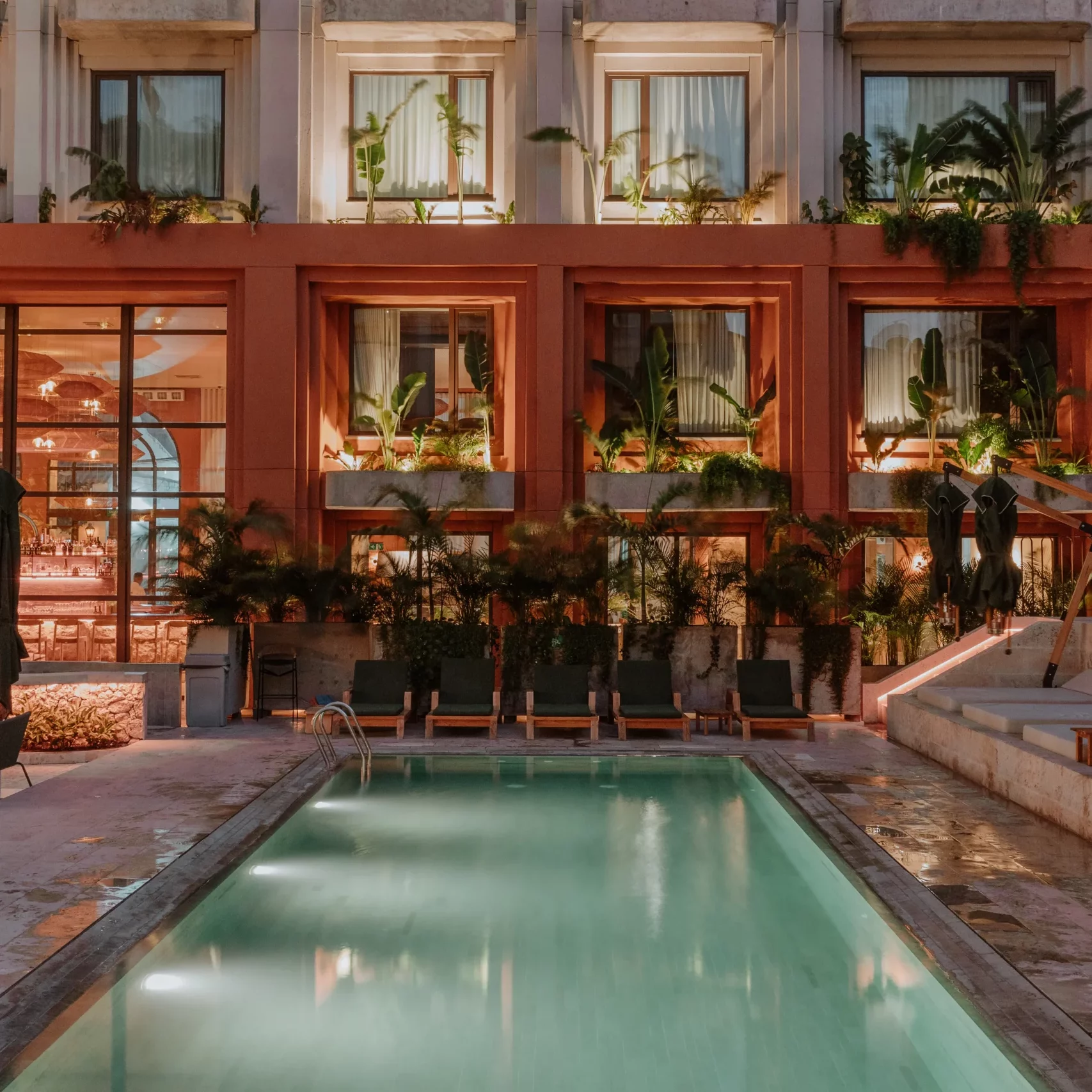 Illuminated pool facing colonial-style hotel facade in Cartagena